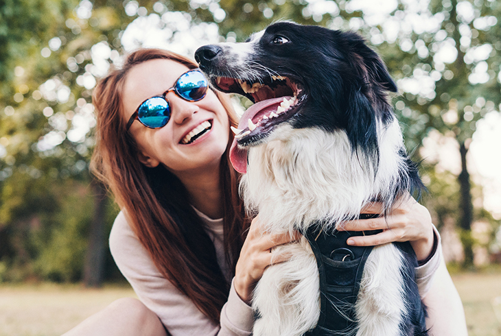 Young woman playing with a dog